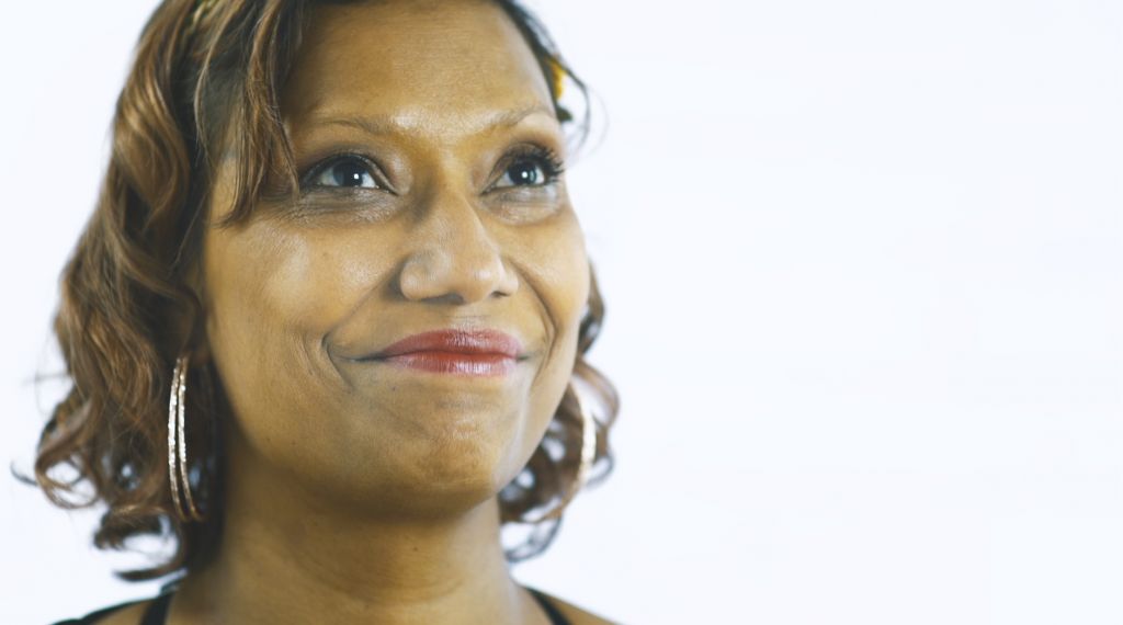 Savvy Boyd - face lit up, eyes looking upward, big smile, after being asked to talk with us about her husband, Leroy.